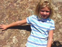 Summer leaning against rock with fossil leaf imprints